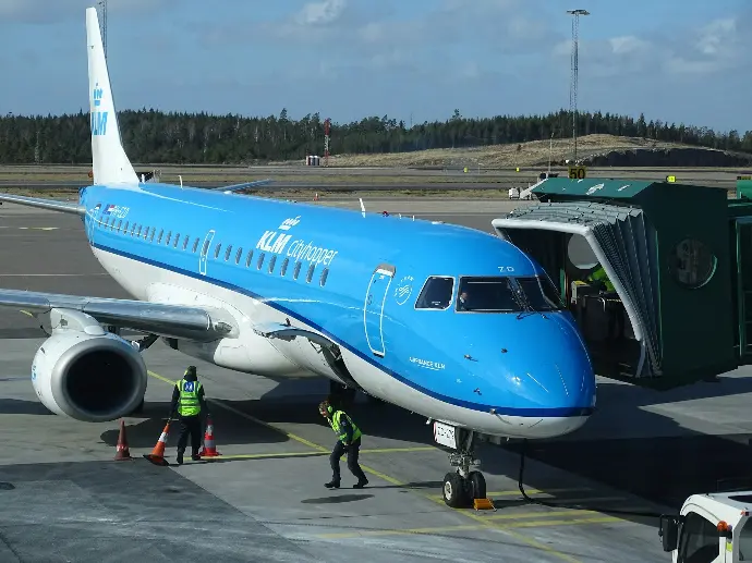 two men doing work near airplane